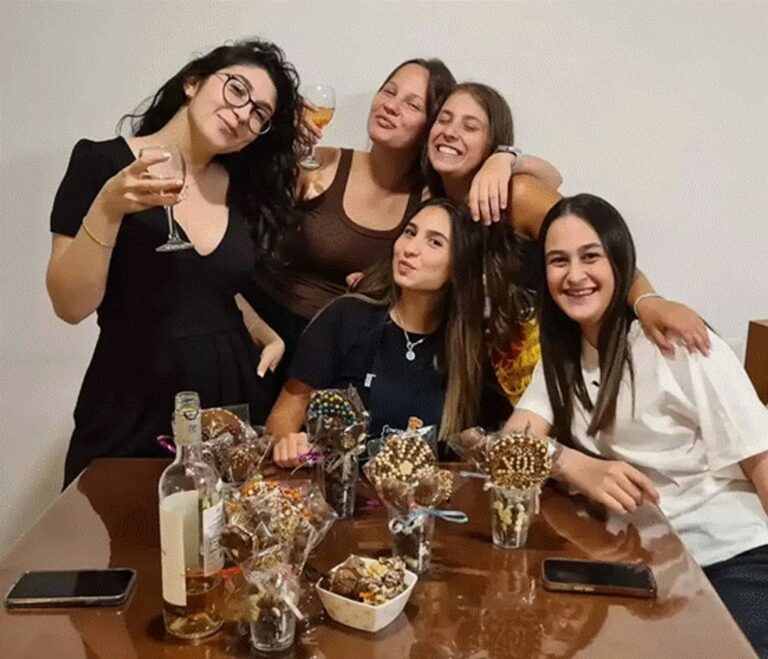 קבוצת נשים מחייכות וחוגגות זמן איכות משותף במהלך סדנת שוקולד בוטיק של עינביז.