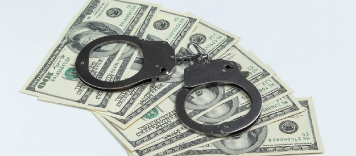 steel-handcuffs-one-hundred-dollar-bills-white-background_175682-7477